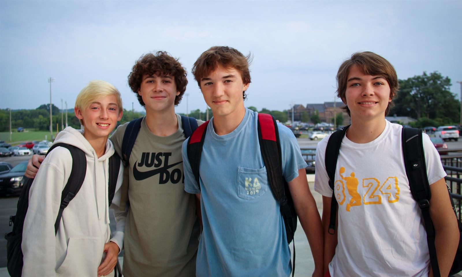 Four students smile